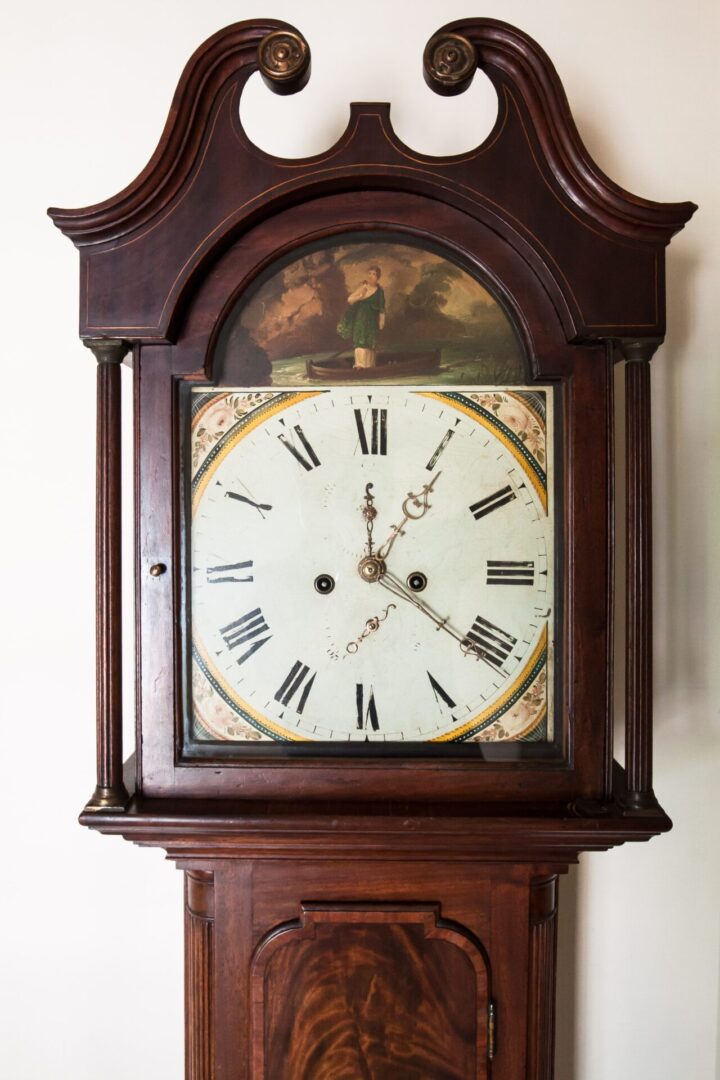 A grandfather clock with an image of a man on the face.