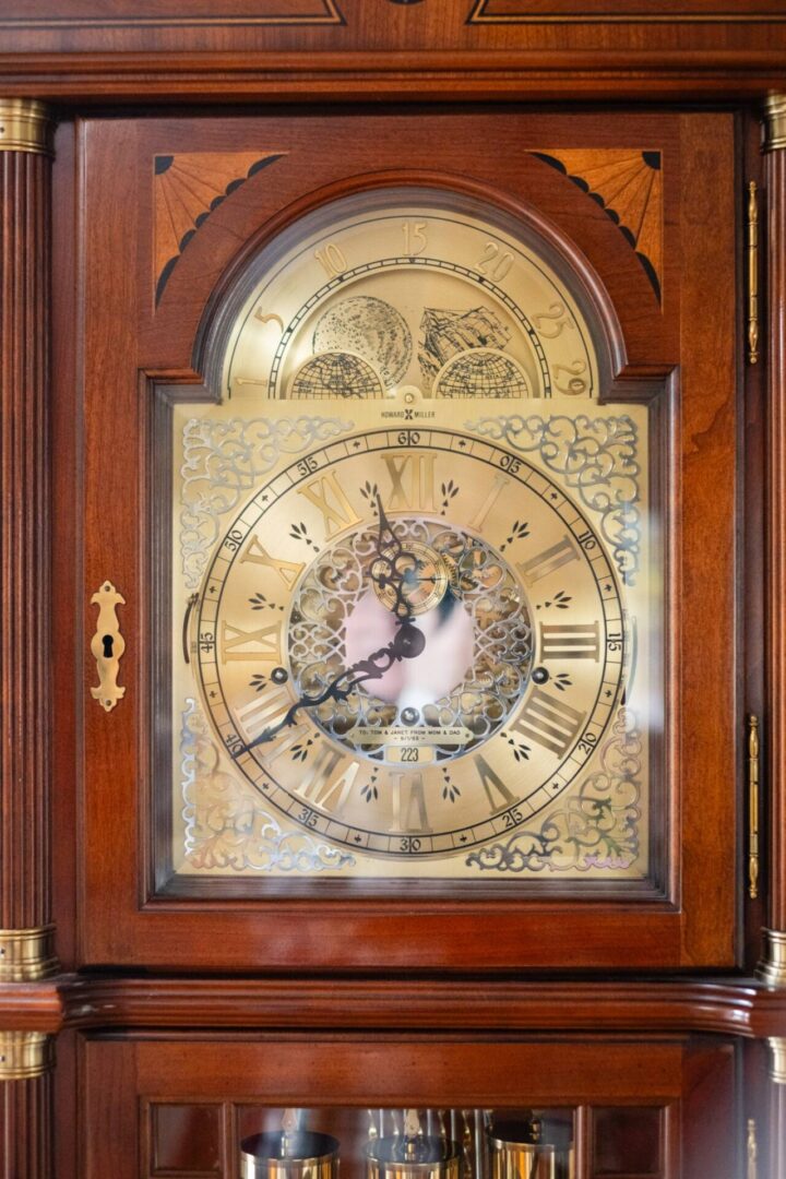 A grandfather clock with the time displayed on it.