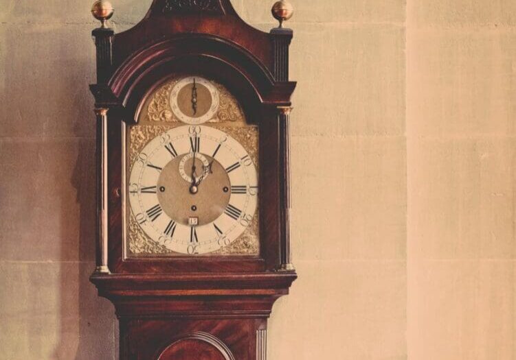 Antique grandfather clock with roman numerals.