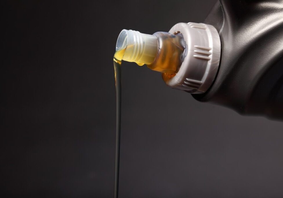 Oil pouring from bottle spout.